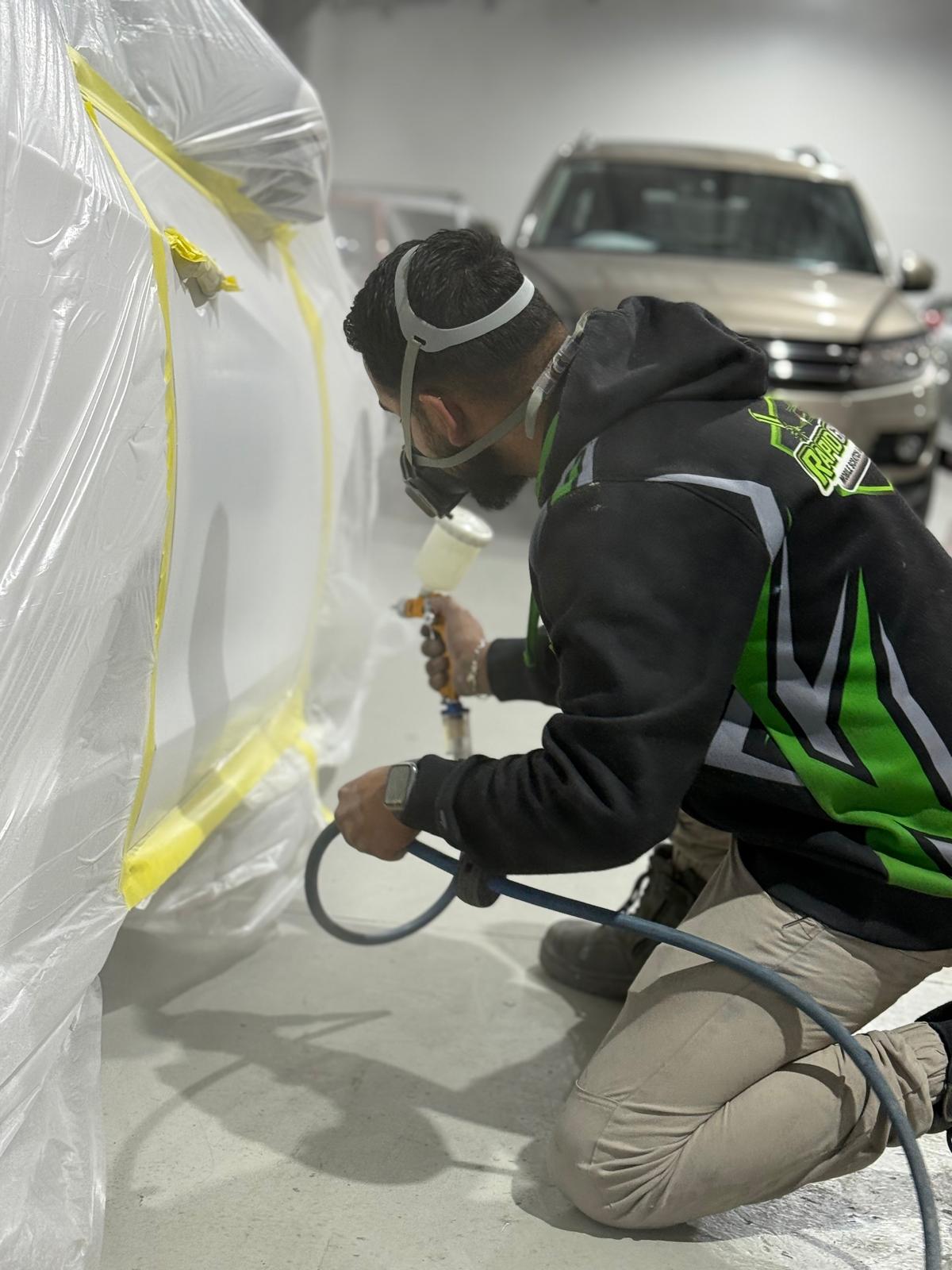 a boy is repairing a car