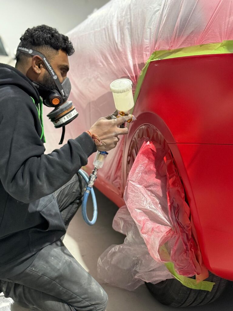 Rapid Gloss Team Repairing a Car